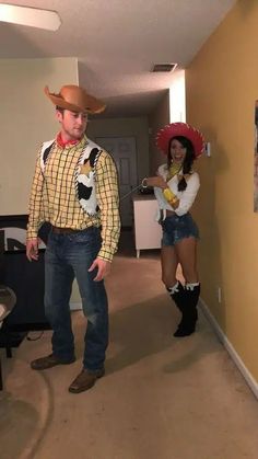 two people dressed up in costumes standing next to each other and one person wearing a cowboy hat