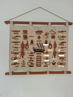 a wall hanging on the side of a white wall with various items attached to it