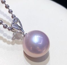 13.1mm Edison Pearl: This Edison pearl pendant uses a 13.1mm perfect round and basically flawless Edison purple pearl, 18k gold diamond accessories, and the diamond is a very shiny t square diamond. Rare violet, this color is very rich violet, and the pearl is very strong, which can illuminate the clear silhouette.The bail is manufactured in 18 karats solid white gold and diamond 💎 .The chain is 45cm long silver 925 white rhodiumOur Pearl Accessory Collection are all 100% Genuine pearls. We onl Elegant Purple Diamond Necklace, Elegant Purple Pearl Necklace For Formal Occasions, Elegant Purple High Luster Jewelry, Elegant High Luster Purple Jewelry, Elegant Purple Pearl Necklace For Wedding, Elegant Purple Jewelry With Pearl Pendant, Elegant Purple Pearl Pendant Necklace, Elegant Purple Round Pearl Necklace, Unique Pearl Necklace