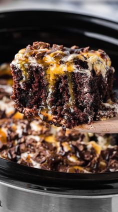 a close up of a piece of cake on a spoon in a crock pot