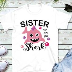 a t - shirt with the words sister do do shark in black and pink on it