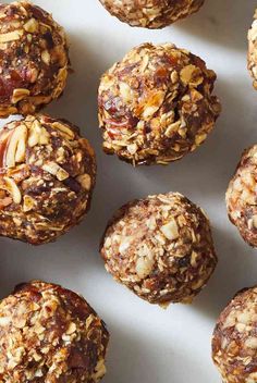 a white plate topped with muffins covered in nuts