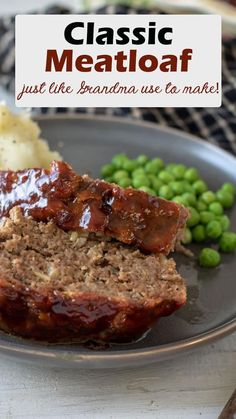 meatloaf on a plate with peas and mashed potatoes