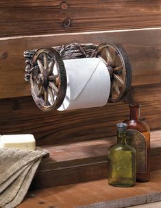 an old fashioned toilet paper roll holder on a wooden shelf next to bottles and soap