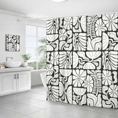 a black and white shower curtain in a bathroom