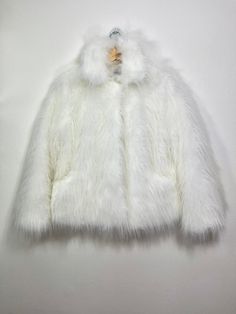 "Off White Short Fur Coat. Luxury, fluffy fabric, very soft. 100% polyester. Handmade made in London, UK.  Regular fit style. Collar. Long sleeves. Metal snap buttons (invisible) Two side pockets. Length 60 cm - 1cm) Handmade in UK.  HOW TO CHOOSE A SIZE ?   Using a measuring tape, measure your bust, waist and hips (widest part) and compere with size chart.  SIZE CHART: (CM) XS - B: 84 W: 66 CM H: 90 S - B: 88 W: 70 CM H: 94 M - B: 92 W: 74 CM H: 98 L - B: 96 W: 78 CM H: 102 XL - B: 100 W: 82 CM H: 106 CARE INSTRUCTIONS: Dry clean only, do not wash, do not iron, do not bleach.  Please message me before purchasing so I can check availability. If you wish this fur in any other colour, shorter or longer \"send message to seller\" and we can try to make something especially for you.  *Depends Short Fur Coat, Short Faux Fur Coat, Fluffy Fabric, White Fur Coat, White Fur, Measuring Tape, White Short, Fit Style, Faux Fur Coat