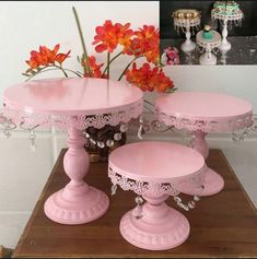 three pink cake stands on top of a wooden table