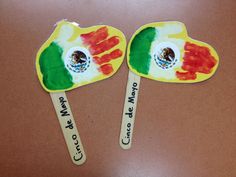 two wooden spoons decorated with the flag of mexico and hand written welcome to mexico