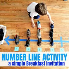 a young boy sitting on the floor with his shoes in front of him and number line activity