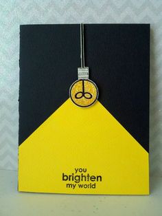 a yellow and black card with a small pendant hanging from it's front end