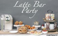 a table topped with lots of food next to a coffee maker and cupcakes