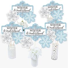 winter wonderland centerpieces with snowflakes in a vase and candy bar wrappers