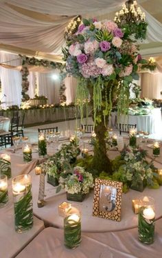 the centerpiece is surrounded by candles and flowers