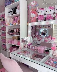 a room filled with lots of hello kitty furniture and accessories on display in front of a mirror