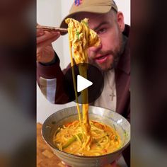 a man is eating noodles from a bowl