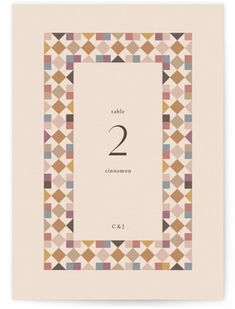 a table number card with geometric shapes and the number two in it's center