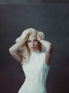 lady in white dress posing with hands on her head