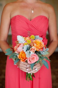 a woman in a red dress holding a bouquet of flowers