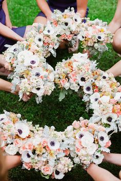 the bridesmaids are holding their bouquets in each other's hands together