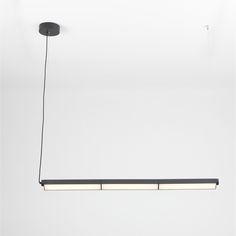 three lights hanging from the ceiling in a room with white walls and black flooring