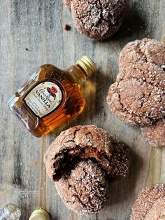 chocolate muffins with powdered sugar on top and bottle of whiskey next to them