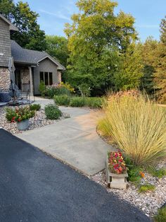 a house with gravel driveway and landscaping in front