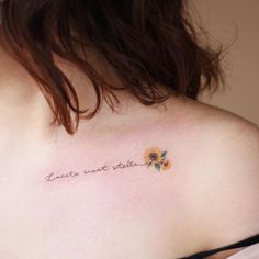 a woman with a sunflower tattoo on her shoulder that says,'love is not state '