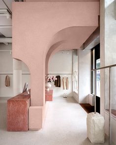 a hallway with pink walls and white floors