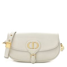 This is an authentic CHRISTIAN DIOR Box Calfskin East West Bobby Bag in Latte. This bag is crafted of smooth calfskin leather with an embossed "30 Montaigne" design on the back. It features an adjustable shoulder strap, polished gold hardware, and opens with a flap to a white suede interior with a patch pocket. Bobby Bag Dior, Luxury Cream Calf Leather Shoulder Bag, Luxury Evening Shoulder Bag With Embossed Logo, Luxury Evening Bags With Embossed Logo, Evening Leather Bag With Embossed Logo, Luxury White Shoulder Bag With Smooth Grain, Elegant Leather Shoulder Bag With Embossed Logo, Elegant Leather Bags With Embossed Logo, Luxury White Shoulder Bag With Embossed Logo