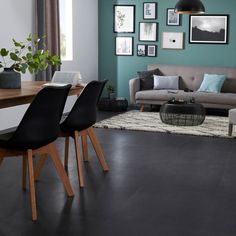 a living room filled with furniture and pictures on the wall