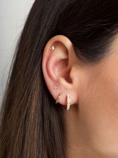 "The tiniest little studs with four teensy zirconia gemstones for the most understated sparkle. Simple and dainty, they're perfect for layering with other delicate hoops and studs when you have multiple piercings. ∙ Sold individually (1 stud) or by pair (2 studs) * D E T A I L S * ∙ Material:  .925 Sterling Silver or 18K Gold Plated over .925 Sterling Silver  ∙ Stone: White Zirconia ∙ Dimensions: 2.5mm ∙ Hypoallergenic & nickel-free * P A C K A G I N G * ∙ All jewelry is sent out beautifully pac 4 Stud Ear Piercing, 3 Earrings In One Ear, Ear Piercings 3 Lobe 1 Cartilage, 3 Earings Piercings Ideas Simple, 4 Earings Piercings Ideas, 4 Earings Piercings, Gold Earrings First And Seconds, Third Piercing And Cartilage, Ear Piercing Ideas Gold Simple