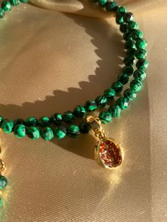 Details: * Gold: Brass + 18K Gold plated * Platinum:  Brass + Rhodium plated * Natural Faceted Malachite stones (3/4 mm); One Zircon Watermelon pendant * No risk of allergy (nickel-free, lead-free, cadmium-free) * Size:  length adjustable 40 + 5 cm; pendant 7 cm (with chain) * The shape and color of the stones may vary * Delivered with a cleaning cloth and a ready-to-gift jewelry storage pouch * FREE USAVEL GIFT BOX +50e GIFT At checkout, you can send your selected items straight to your friend Watermelon Earrings, Watermelon Necklace, Fruit Necklace, Fruit Jewelry, Malachite Stone, Gold Brass, Jewelry Storage, Storage Pouch, Stone Necklace