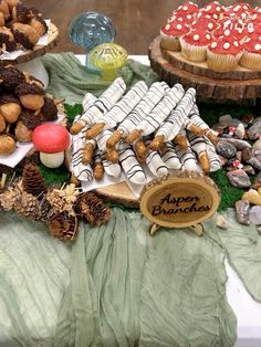 a table topped with lots of desserts and pastries