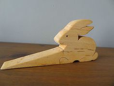 a wooden toy rabbit sitting on top of a table