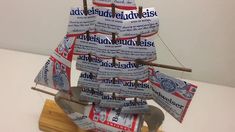 a model ship made out of newspapers on a wooden board