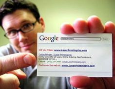 a man holding up a business card in front of his face with the google logo on it