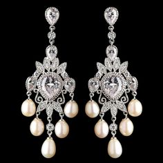 a pair of pearl and diamond earrings