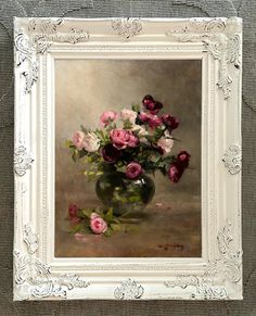 a painting of pink and white flowers in a glass vase on a gray background with silver frame