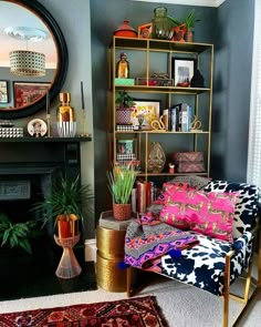 a living room filled with furniture and a fire place next to a mirror on the wall