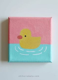 a pink and blue square with a rubber ducky on it