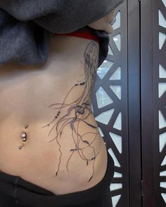 a woman's stomach with a jelly tattoo on her belly and the bottom part of her lower body