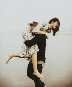 two people hugging each other on the beach with an arabic text above them that reads,