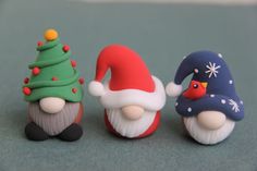 three small figurines in the shape of santa claus, snowman and elf