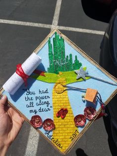 someone is holding up a decorated graduation cap