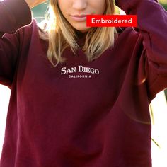 "*SIZES ARE UNISEX* -I'd suggest your usual size for a regular fit, or sizing up for a more relaxed fit. *these sweatshirts are extra comfy when oversized \"San Diego California\" embroidered on a comfy cute crewneck. A sturdy and warm sweatshirt bound to keep you warm in the colder months. A pre-shrunk, classic fit sweater that's made with air-jet spun yarn for a soft feel and reduced pilling. Your new favorite sweatshirt! * 50% cotton, 50% polyester * Pre-shrunk * Classic fit with no center cr Trendy College Sweatshirt With Embroidered Text, College Crew Sweatshirt With Embroidered Logo, Crew Neck Hoodie With Embroidered Logo For College, Fall Streetwear Sweater With Letter Embroidery, College Fall Sweatshirt With Embroidered Text, Fall College Sweatshirt With Embroidered Text, Fall School Spirit Embroidered Sweatshirt, College Sweater With Embroidered Logo And Relaxed Fit, College Crew Sweater With Embroidered Logo