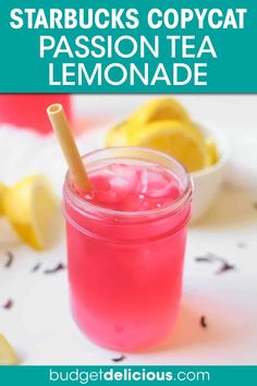 a mason jar filled with pink lemonade and topped with a straw in the middle