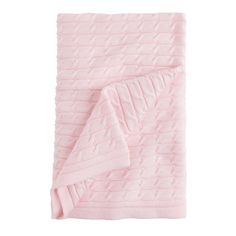 a pink blanket folded on top of a white background with an image of a cabled design