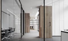 an office with glass walls and wooden doors