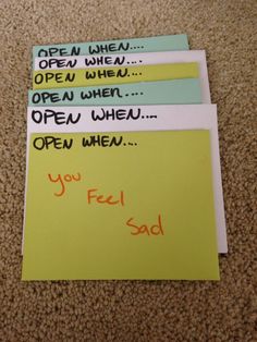 four pieces of paper with words written on them sitting on the floor next to each other