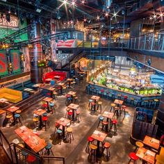 the inside of a restaurant with tables and stools